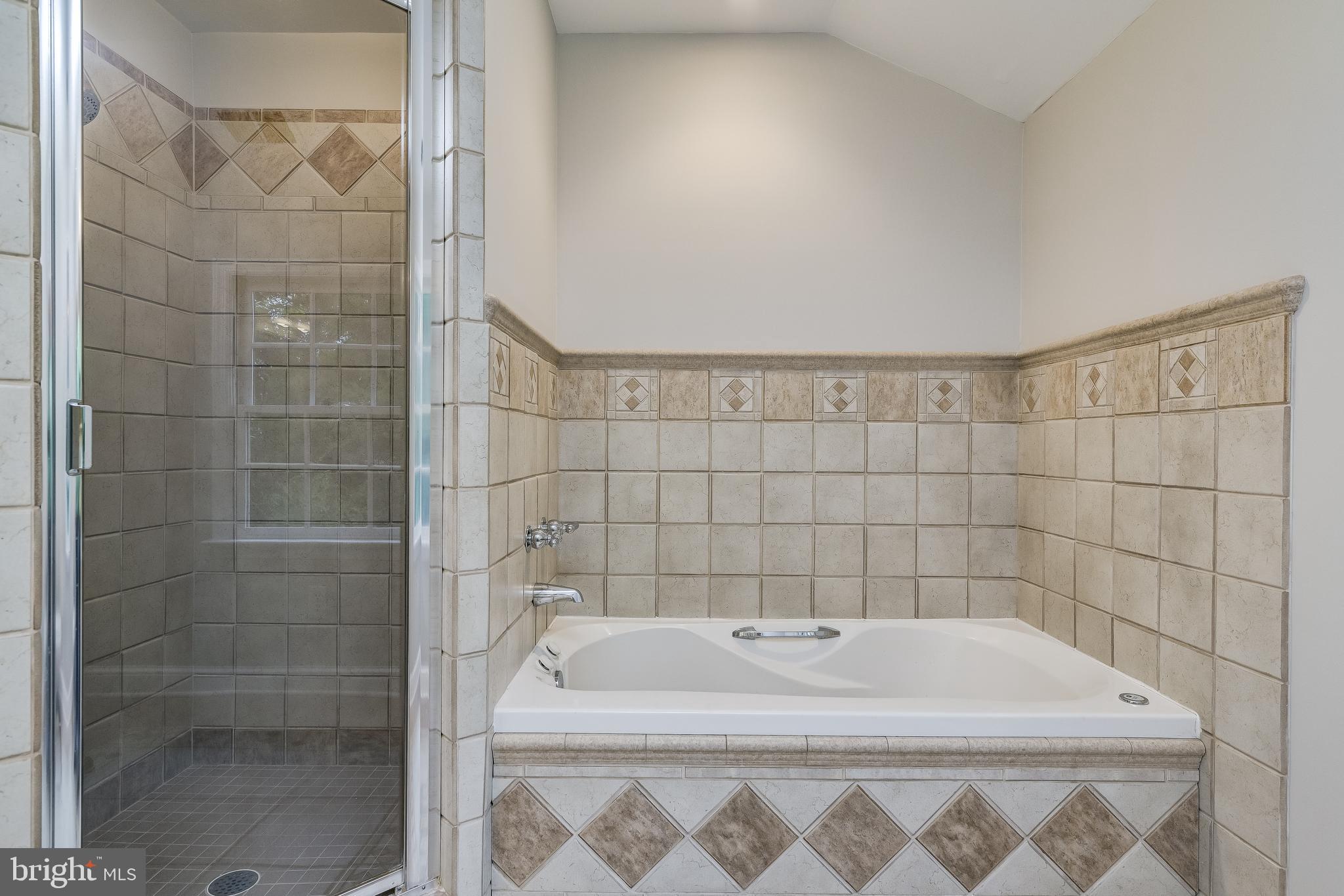 5911 Gloster Road Bethesda, MD 20816 - Photo 43 of 79 Primary Bathroom with jet tub, glass shower door.