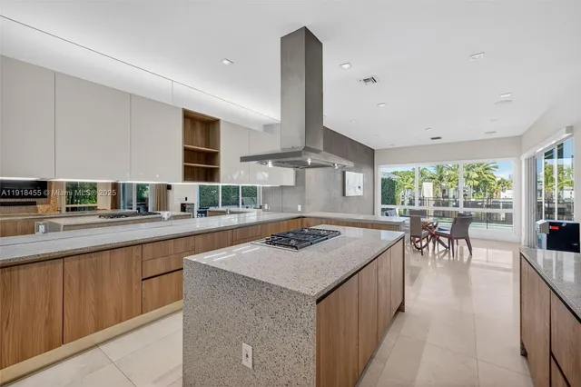 a kitchen with a sink a counter top space and living room area