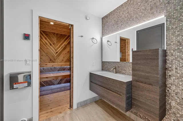 a kitchen with stainless steel appliances granite countertop a refrigerator a stove and a wooden floors