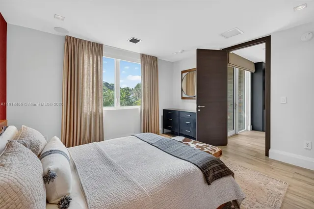a view of a big room with wooden floor and windows