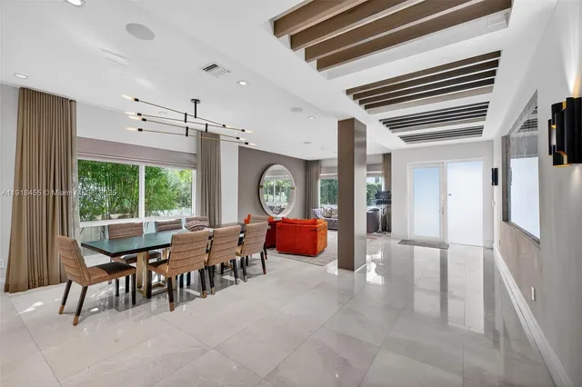 a very nice looking room with a large window and furniture