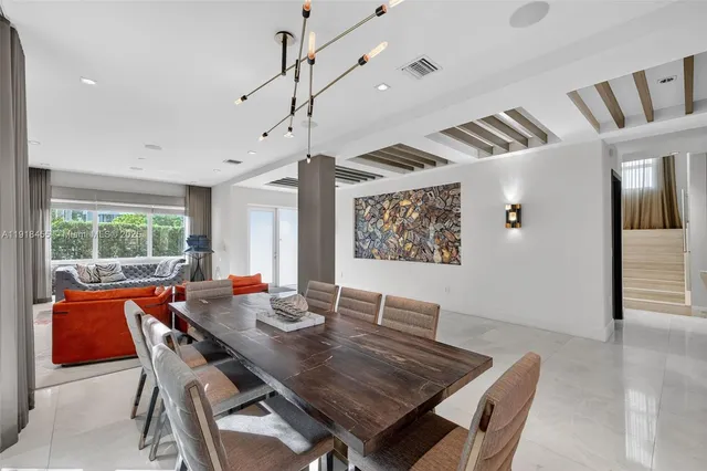 a dining room with furniture a rug and wooden floor