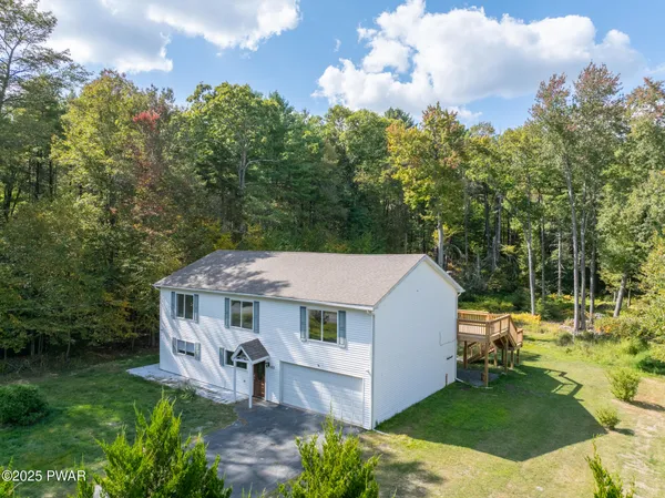 an aerial view of a house with a big yard