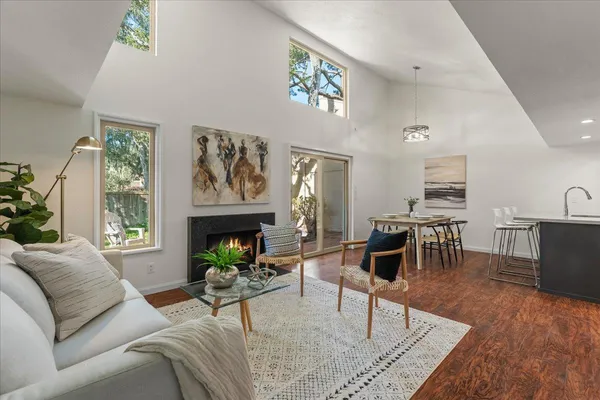 a living room with furniture a fireplace and a table
