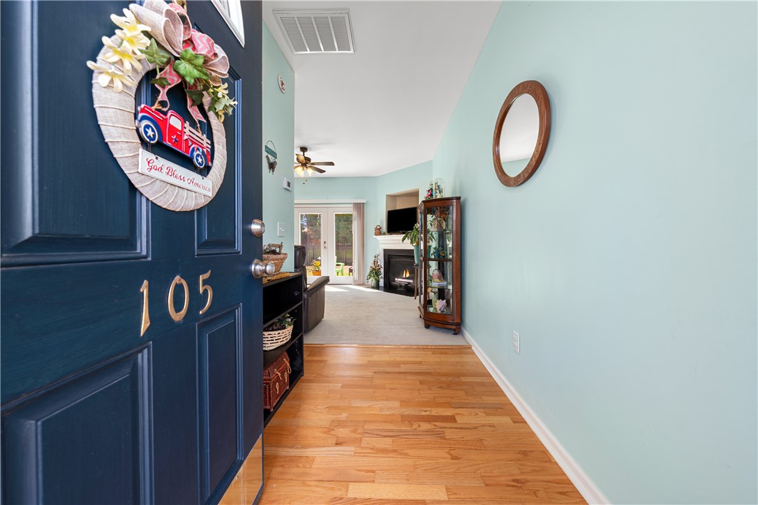 105 Ledgewood Way Easley, SC 29642 - Photo 3 of 35 Enter into a welcoming interior featuring warm flooring and a cozy fireplace.