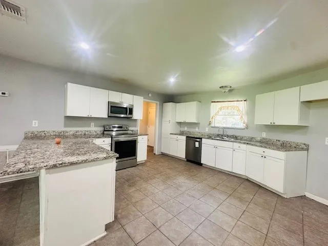a kitchen with a sink stove and cabinets