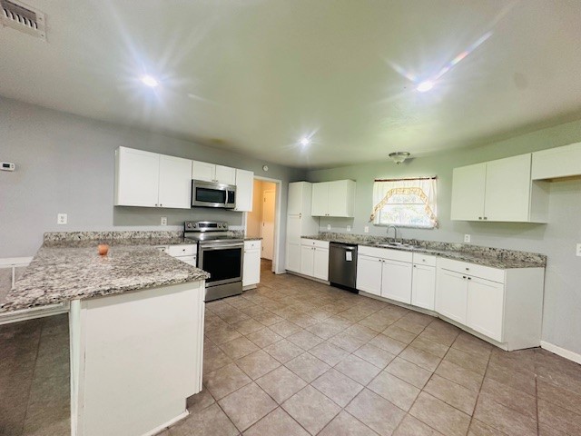 409 Koehl Street Wharton, TX 77488 - Photo 5 of 17 a kitchen with a sink stove and cabinets