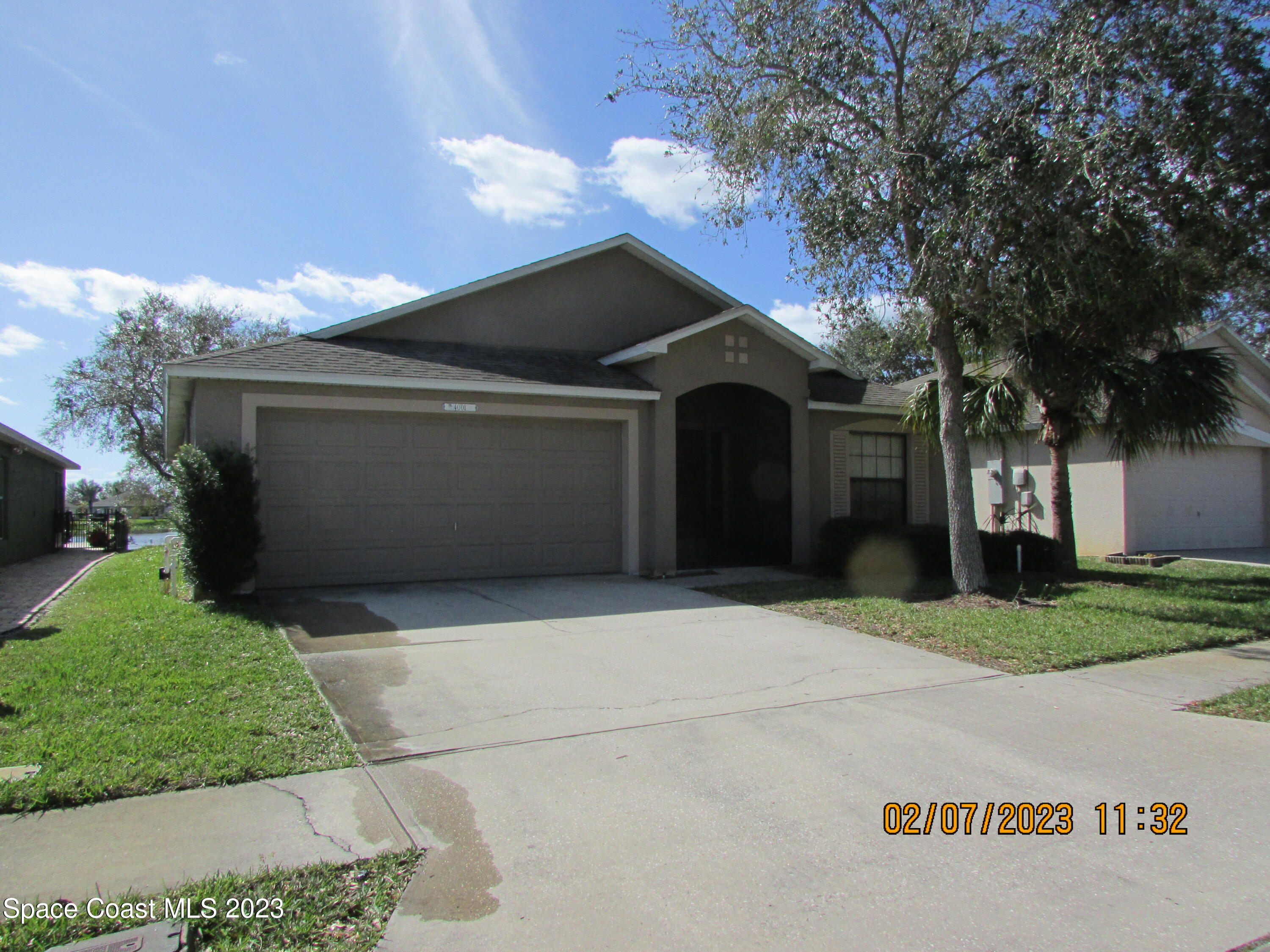 4001 Wilkes Drive Melbourne, FL 32901 - Photo 1 of 21 a front view of a house with a yard and garage