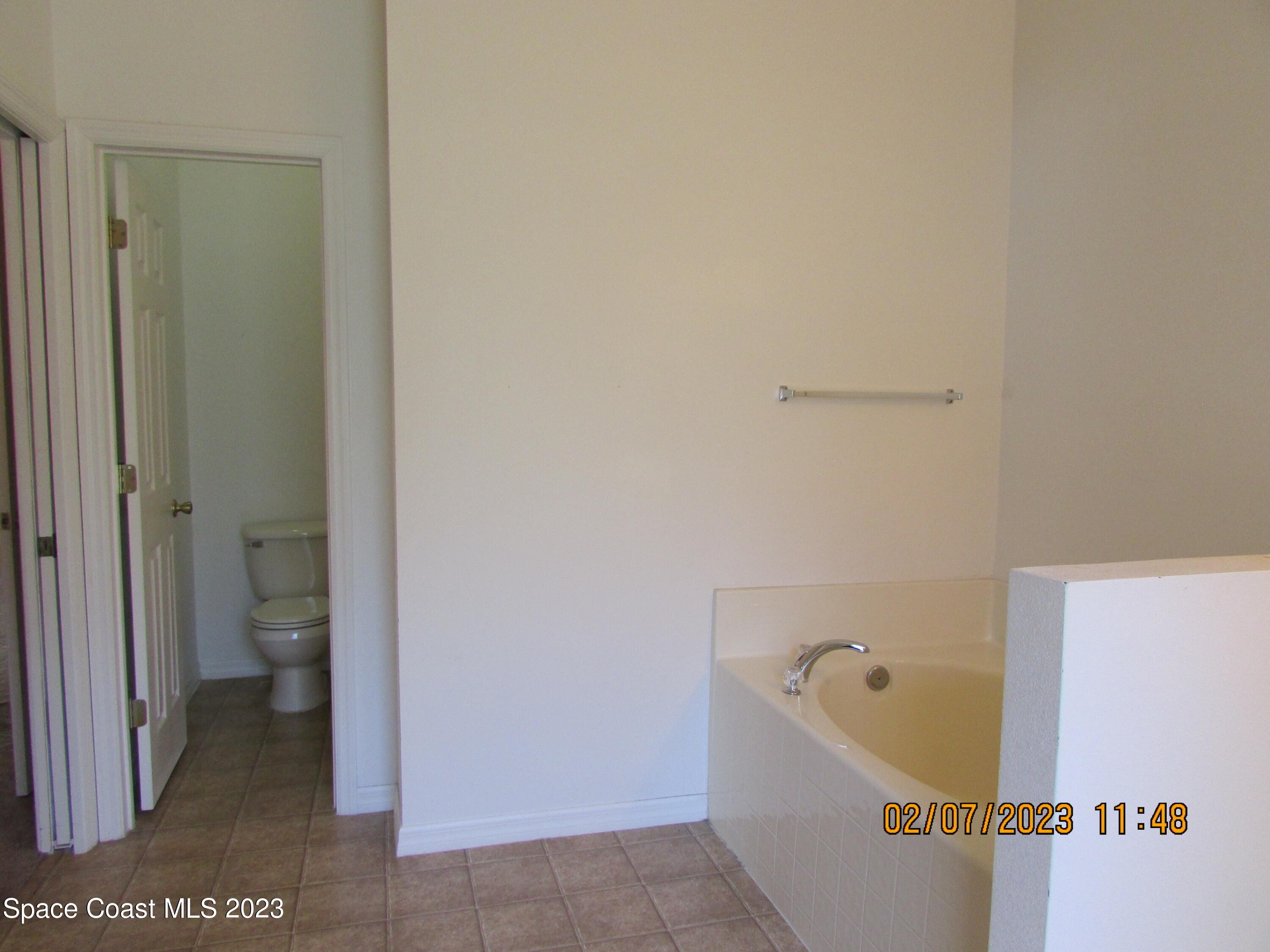 4001 Wilkes Drive Melbourne, FL 32901 - Photo 17 of 21 a bathroom with a bathtub and toilet