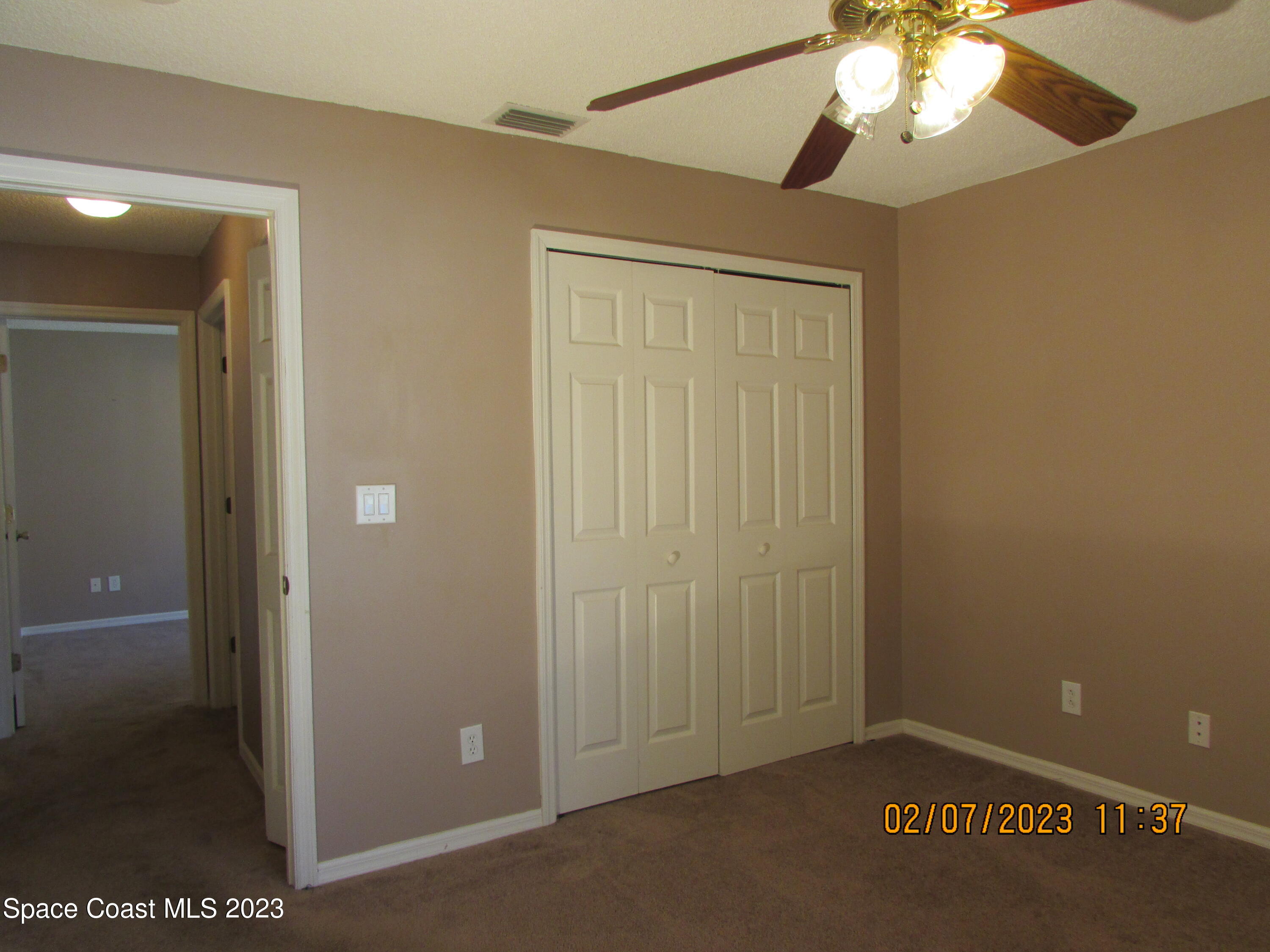 4001 Wilkes Drive Melbourne, FL 32901 - Photo 3 of 21 a view of a hallway with a chandelier fan