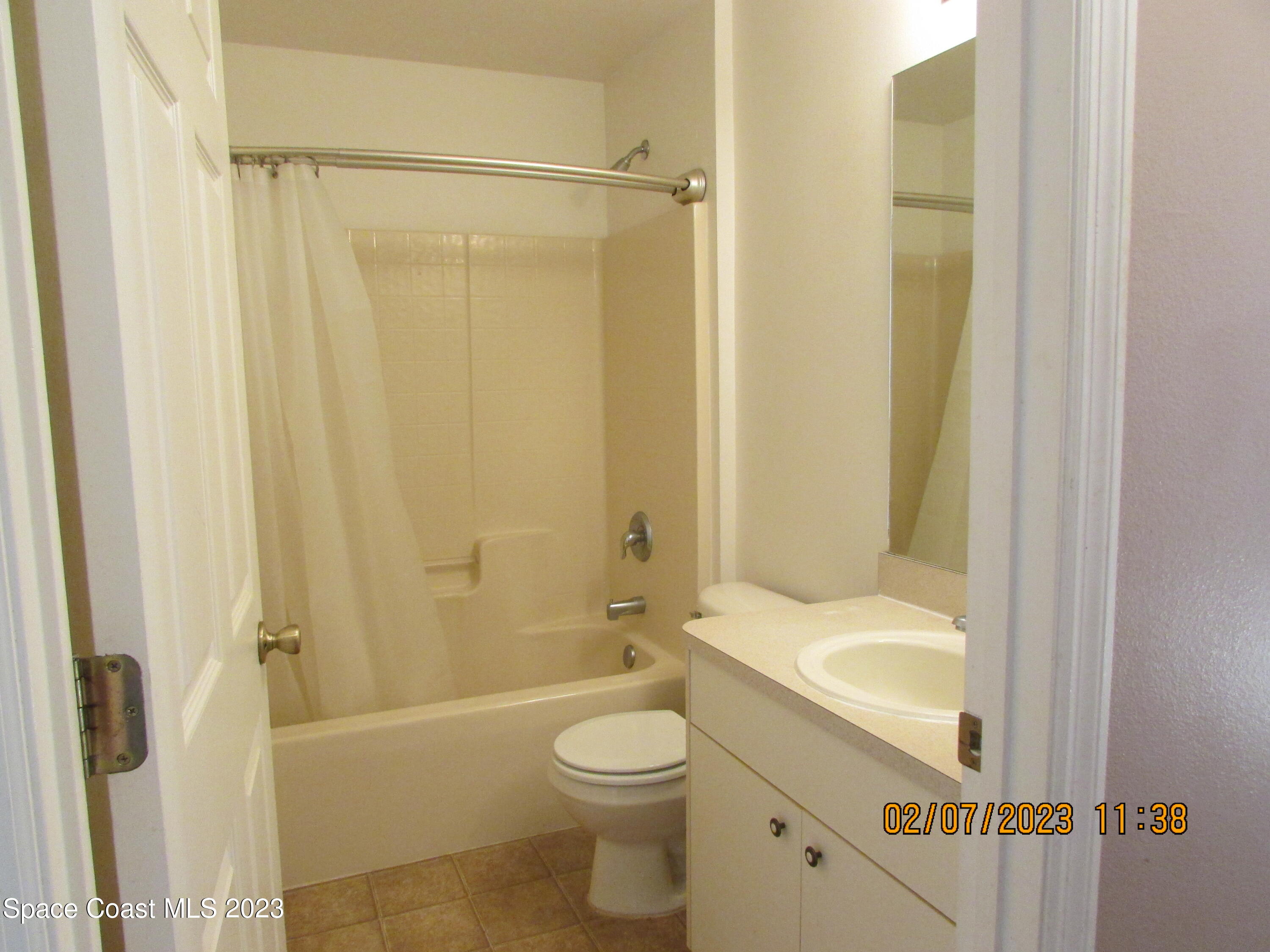 4001 Wilkes Drive Melbourne, FL 32901 - Photo 4 of 21 a bathroom with a granite countertop bathtub shower sink vanity and toilet