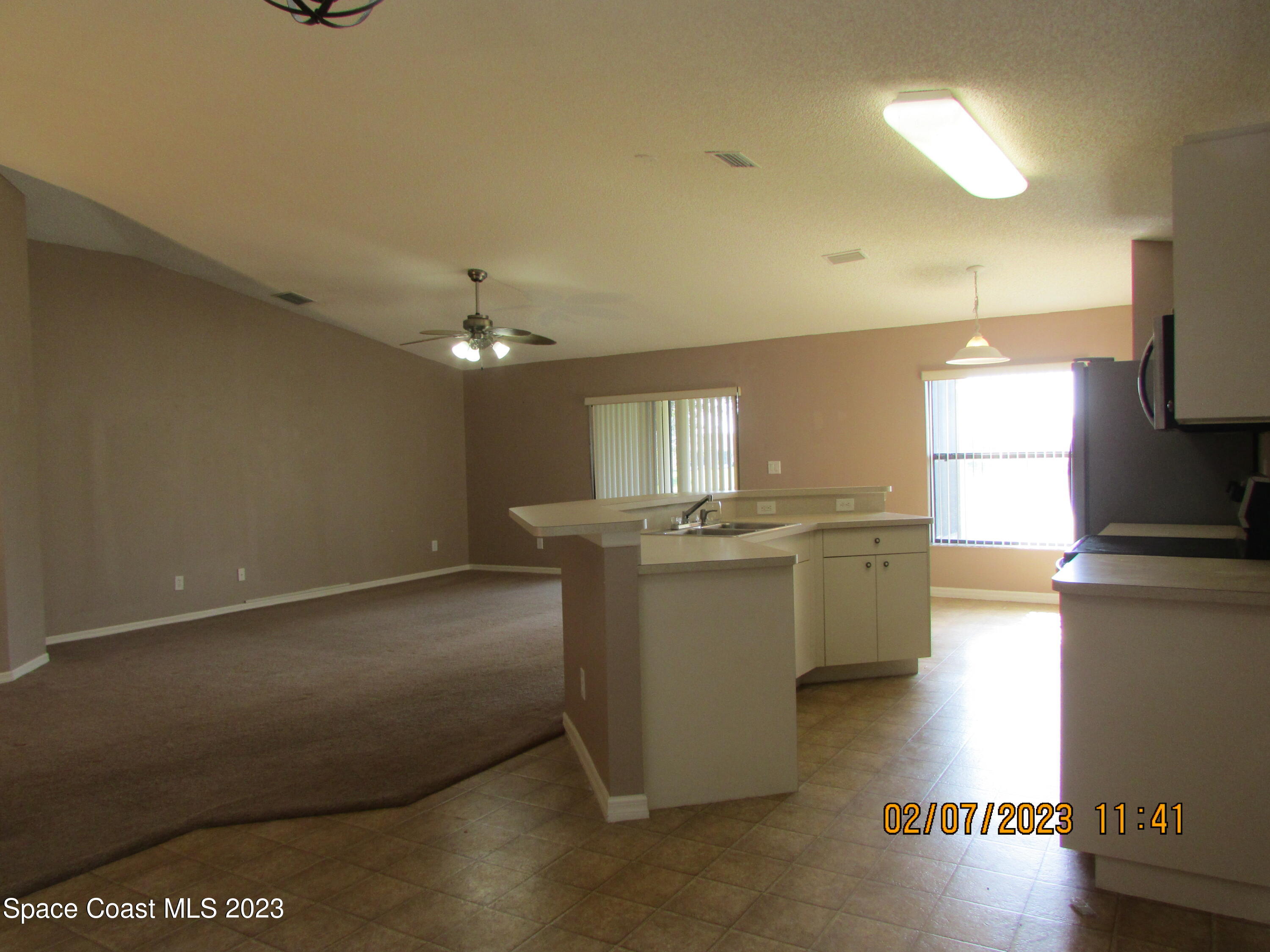 4001 Wilkes Drive Melbourne, FL 32901 - Photo 8 of 21 a view of a kitchen with kitchen island a sink stainless steel appliances and cabinets