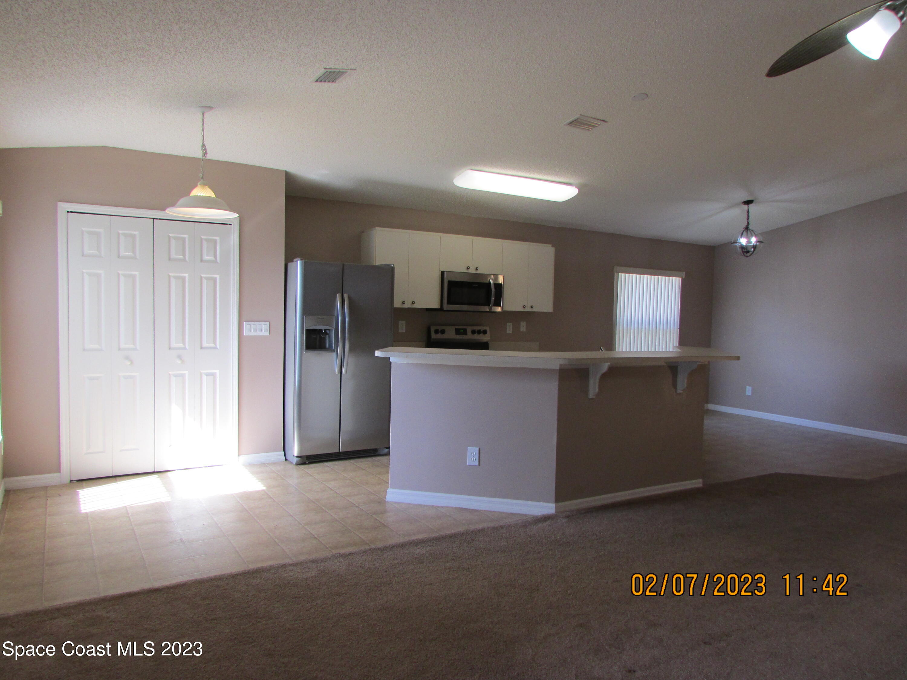 4001 Wilkes Drive Melbourne, FL 32901 - Photo 10 of 21 a kitchen with stainless steel appliances kitchen island granite countertop a stove a sink and a refrigerator
