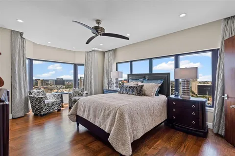 a bedroom with a large bed and a large window
