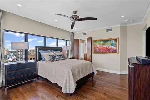 a bedroom with a bed and a painting on the wall