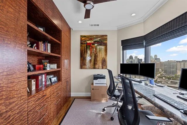 a view of a workspace with furniture and a book shelf