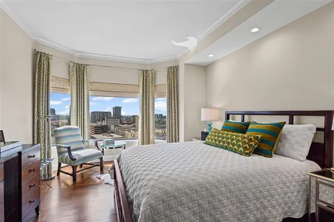 a bedroom with a bed and a large window