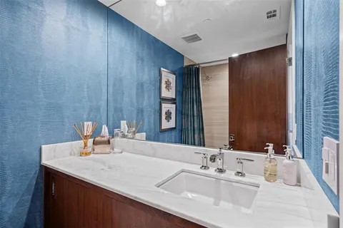 a bathroom with a double vanity sink and a mirror