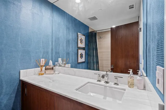 a bathroom with a double vanity sink and a mirror
