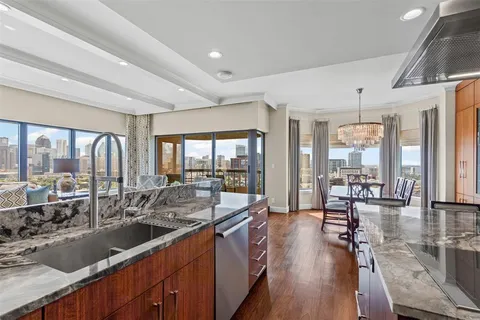 a large kitchen with a large window and furniture