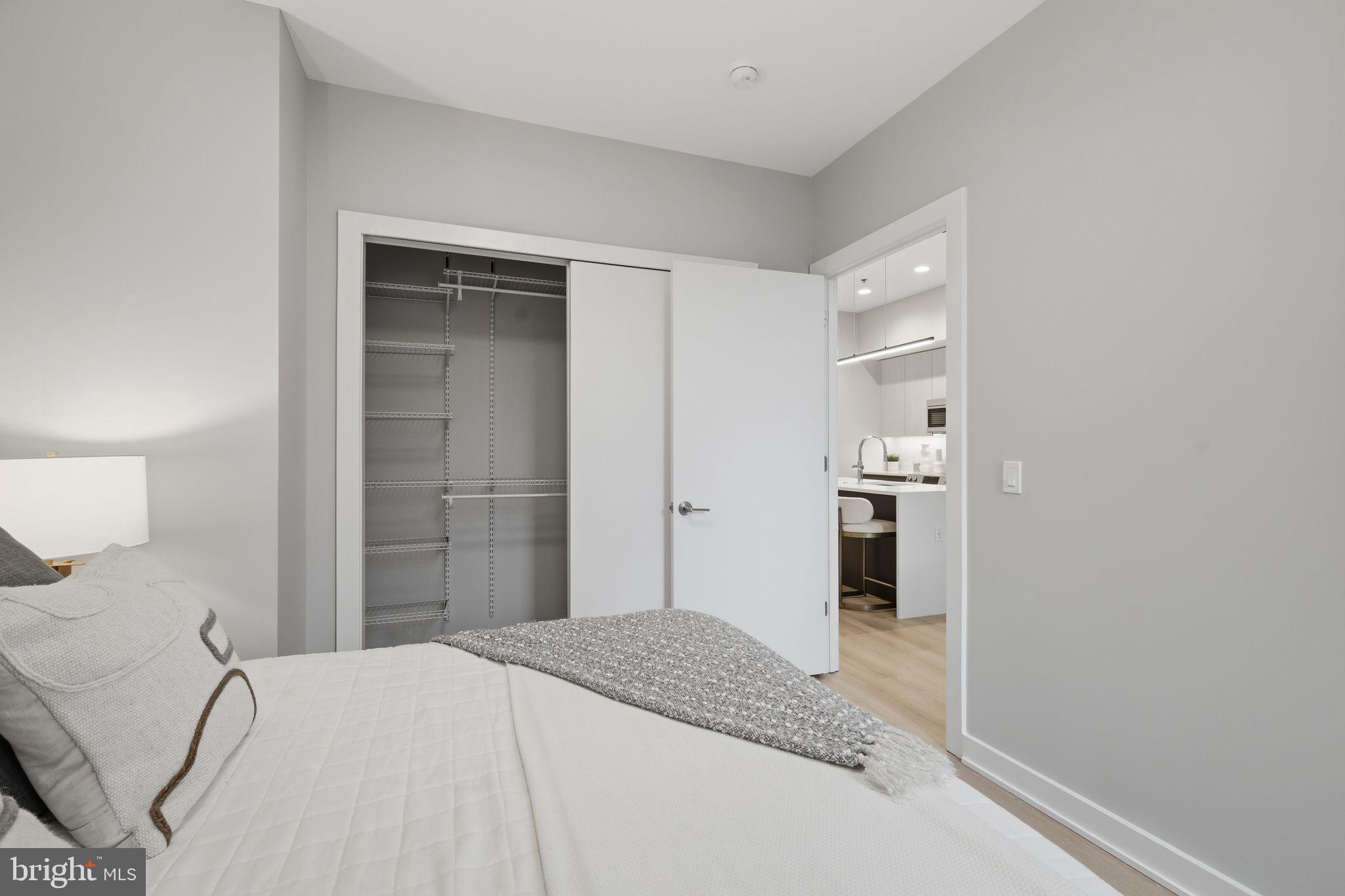 950 3rd Street Northwest, Unit 103 Washington, DC 20001 - Photo 29 of 32 a bedroom with a bed and a bathroom in it