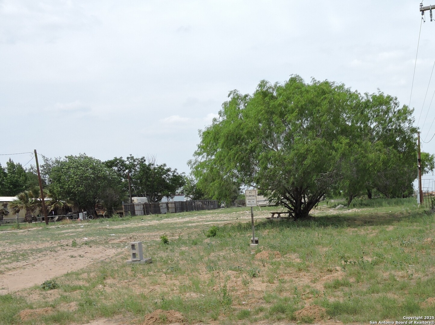 5968 Tabberer Road Poteet, TX 78065 - Photo 7 of 7 a view of a field with trees in the background