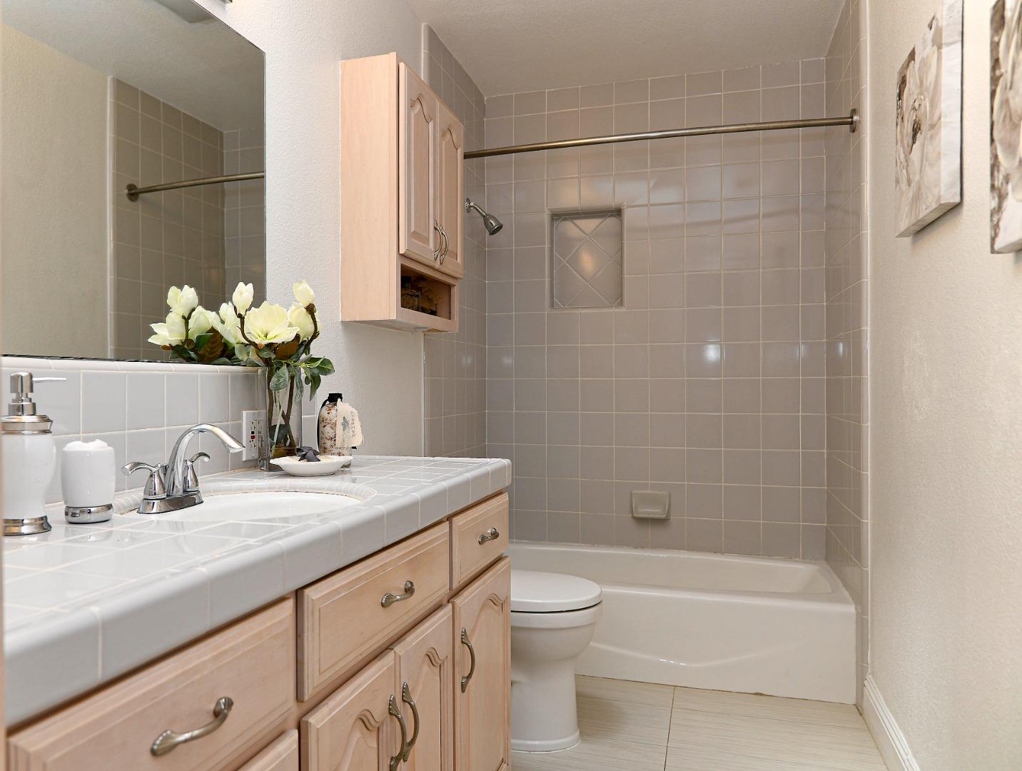 3956 Vía Salice Campbell, CA 95008 - Photo 11 of 21 a bathroom with a granite countertop sink a toilet and shower