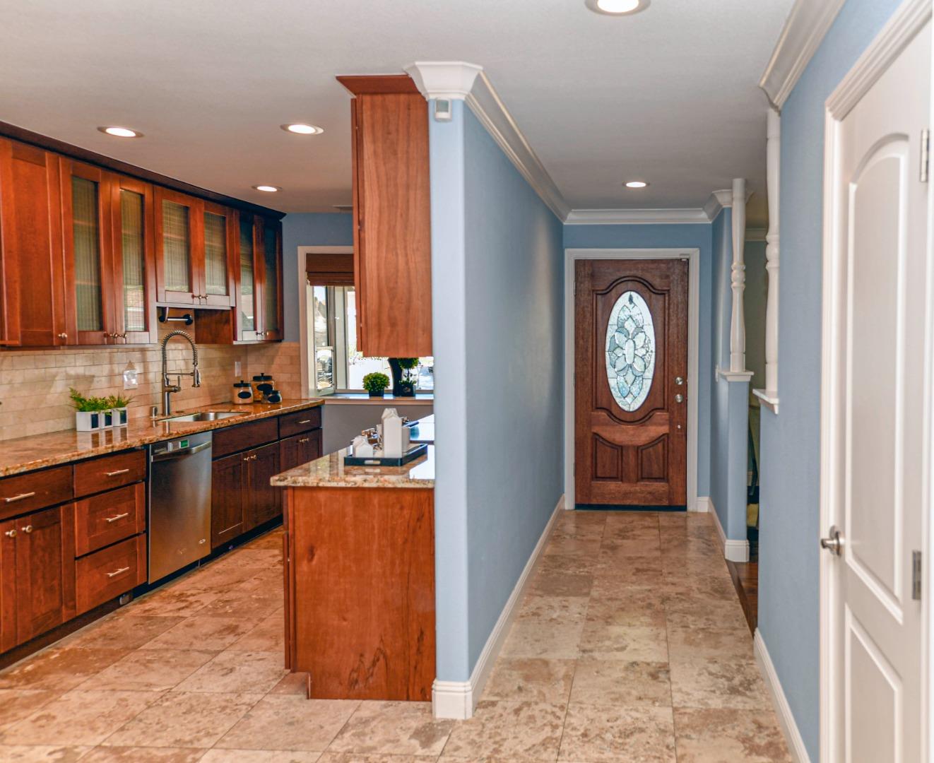 3956 Vía Salice Campbell, CA 95008 - Photo 5 of 21 a kitchen with stainless steel appliances granite countertop a refrigerator a sink and wooden cabinets