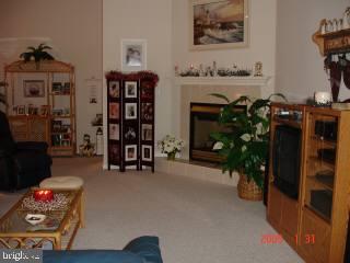 209 Windjammer Road Ocean Pines, MD 21811 - Photo 3 of 4 a living room with furniture and a fireplace