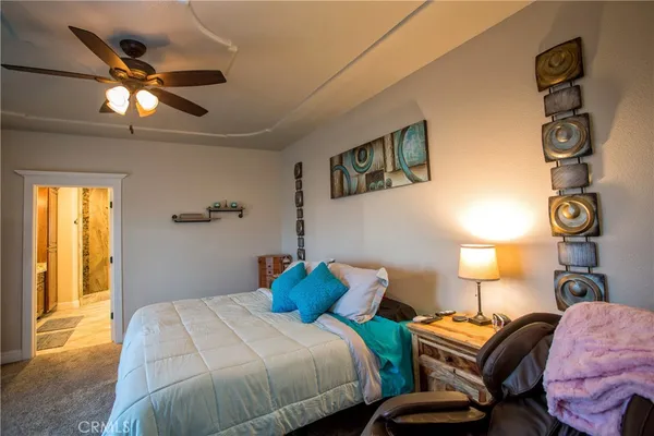 a bathroom with a granite countertop double vanity sink mirror and shower