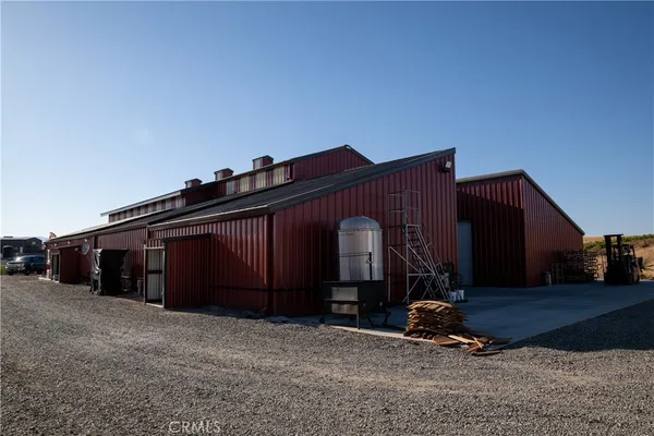 a kitchen with stainless steel appliances a sink a stove a refrigerator and cabinets