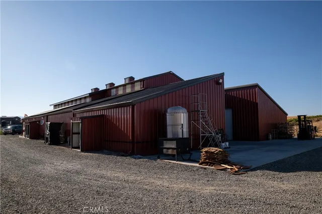 a kitchen with stainless steel appliances a sink a stove a refrigerator and cabinets