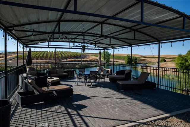 a view of a patio with dining table and chairs