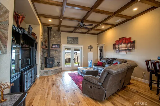 a view of a dining room with furniture a chandelier and wooden floor