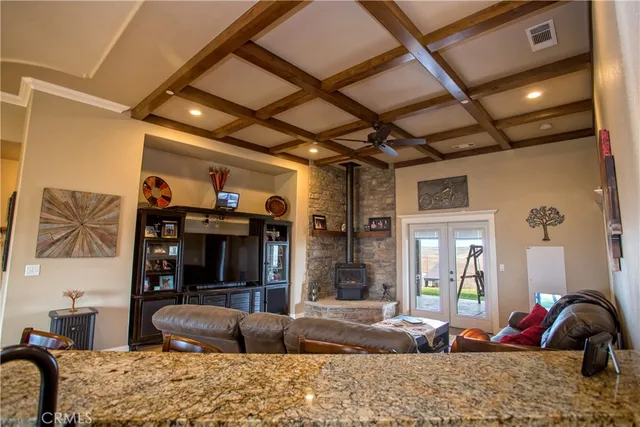 a room with furniture pool table and glass windows