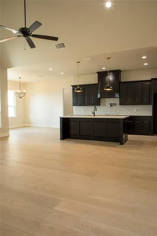 a kitchen with stainless steel appliances a stove sink and cabinets