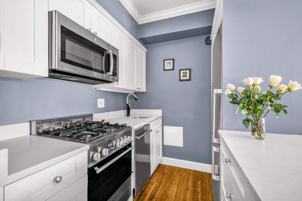 11 Riverside Drive, Unit 5PW Manhattan, NY 10023 - Photo 3 of 10 a kitchen with a sink stove and microwave