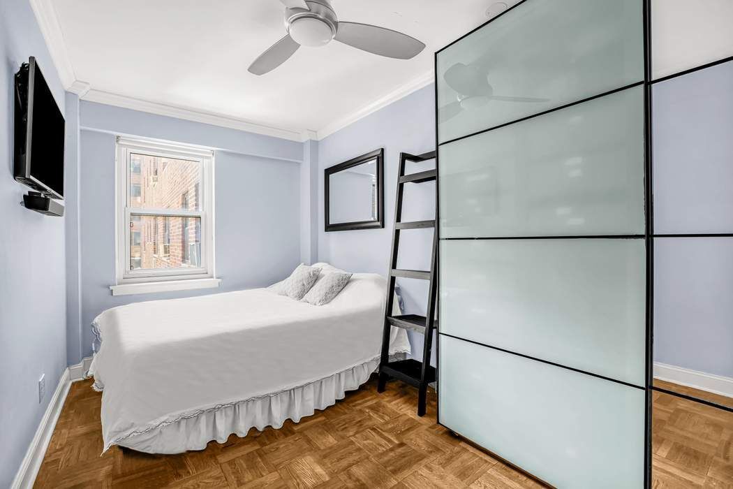 11 Riverside Drive, Unit 5PW Manhattan, NY 10023 - Photo 5 of 10 a bedroom with a bed and a flat screen tv