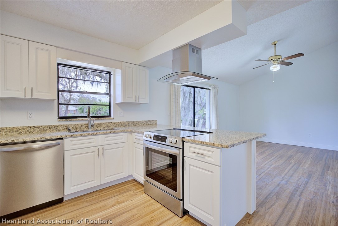 2052 West Stryker Road Avon Park, FL 33825 - Photo 14 of 45 a kitchen with a stove oven and sink