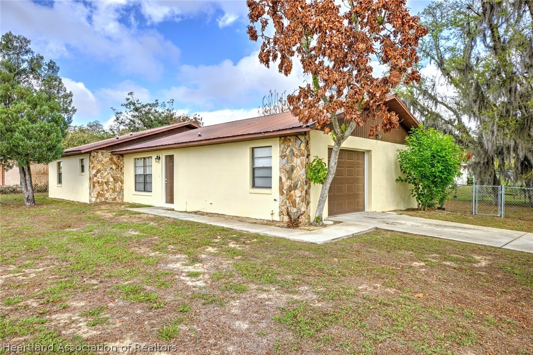 2052 West Stryker Road Avon Park, FL 33825 - Photo 2 of 45 a view of a house with a yard and large tree
