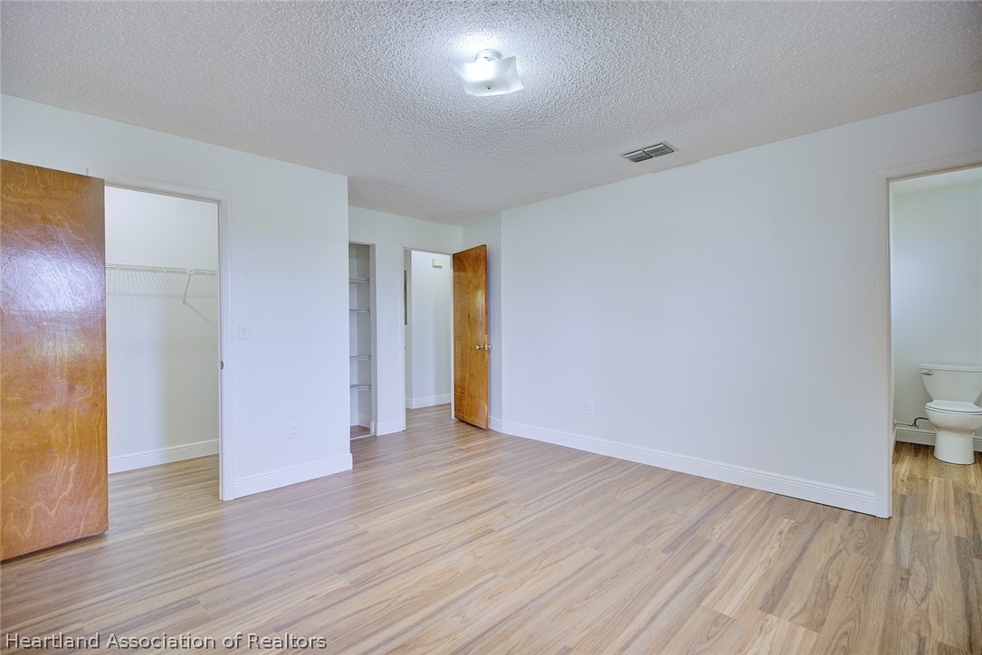 2052 West Stryker Road Avon Park, FL 33825 - Photo 23 of 45 a view of an empty room with wooden floor and a window