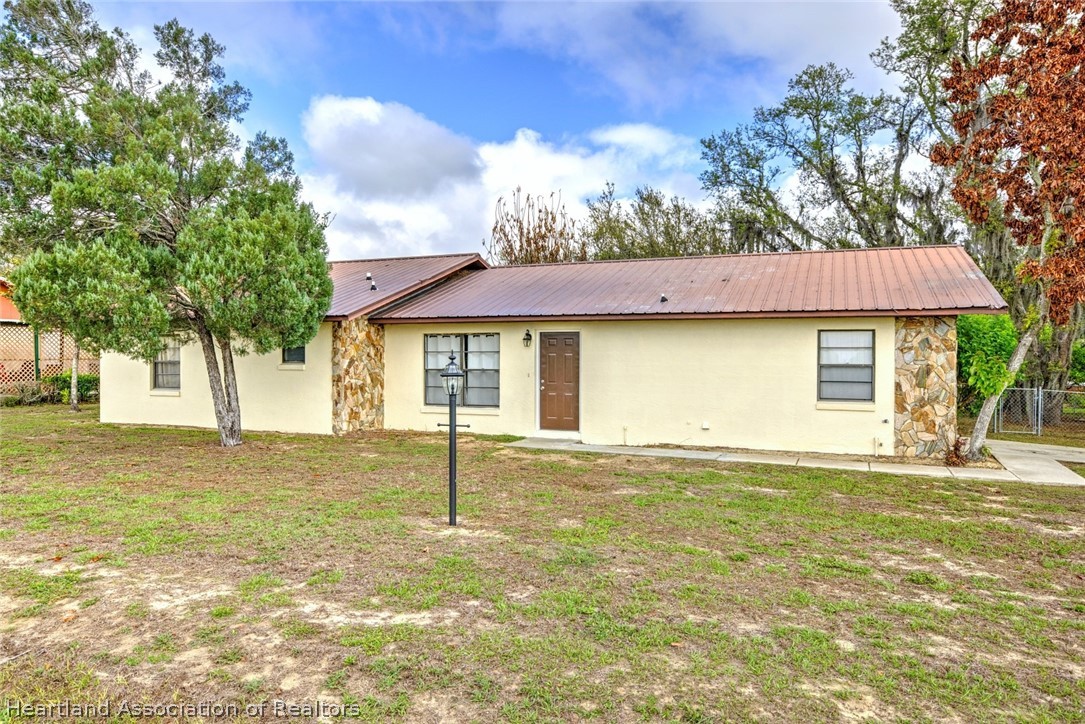 2052 West Stryker Road Avon Park, FL 33825 - Photo 3 of 45 a view of a house with a backyard