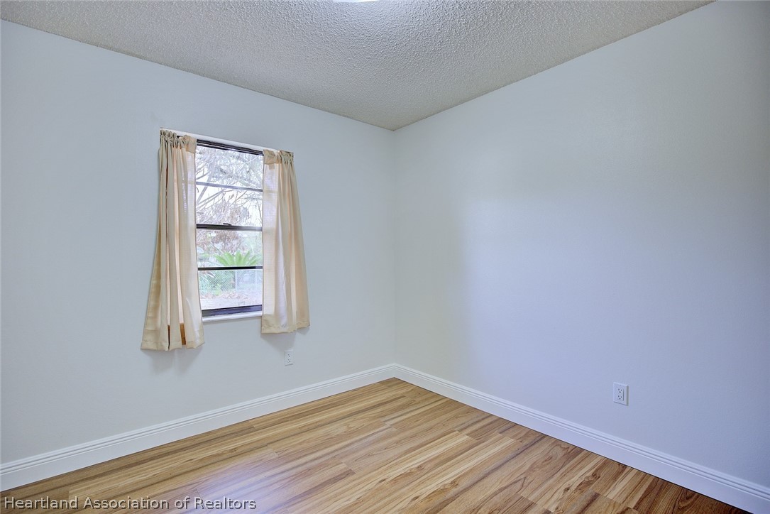 2052 West Stryker Road Avon Park, FL 33825 - Photo 33 of 45 a view of empty room with wooden floor and fan