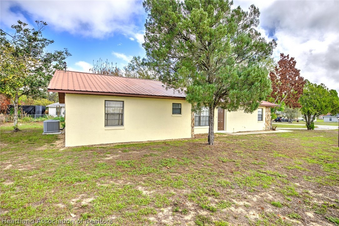 2052 West Stryker Road Avon Park, FL 33825 - Photo 4 of 45 a house with trees in front of it