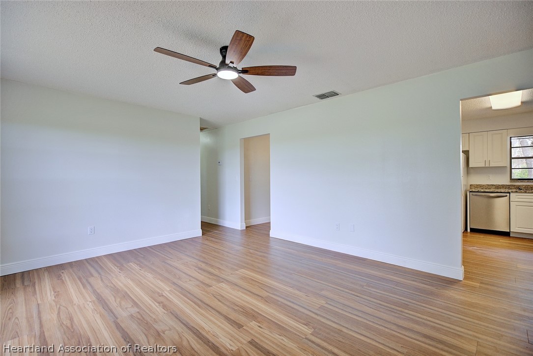 2052 West Stryker Road Avon Park, FL 33825 - Photo 6 of 45 a view of a big room with wooden floor a ceiling fan and closet