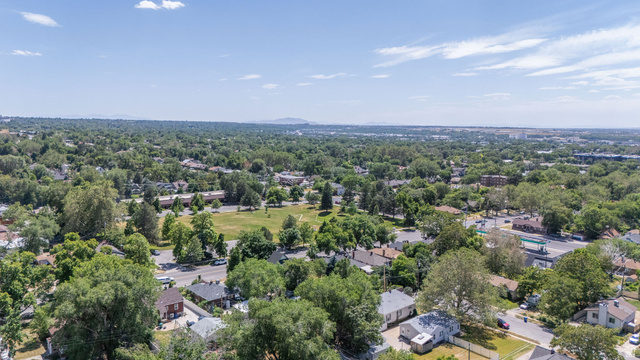 1256 24th Street Ogden, UT 84401 - Photo 29 of 34 Expansive aerial perspective showcasing a verdant residential landscape with mature trees and a clear sky