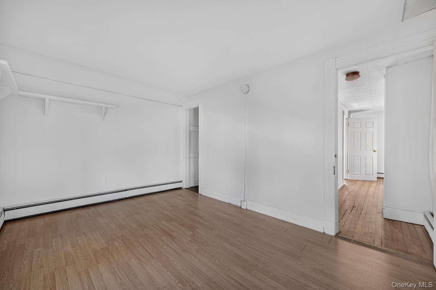 49 Cedar Street Babylon, NY 11702 - Photo 12 of 20 a view of an empty room with wooden floor