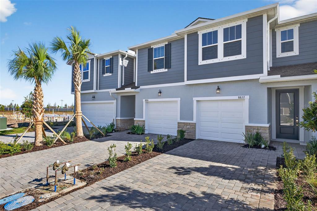 8822 Ginko Run Parrish, FL 34219 - Photo 2 of 30 a front view of a house with a yard