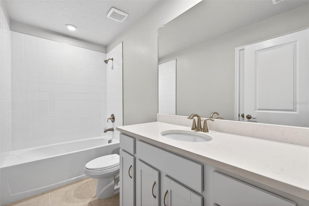 8822 Ginko Run Parrish, FL 34219 - Photo 26 of 30 a bathroom with a sink a toilet and shower