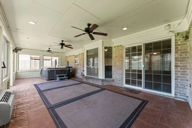 a living room with furniture a fireplace and next to a window